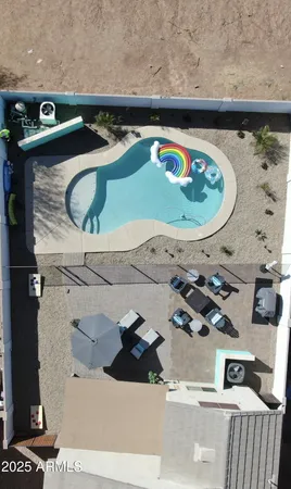 a view of a chairs and table in the back yard of the house