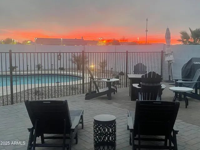 a backyard of a house with barbeque oven table and chairs