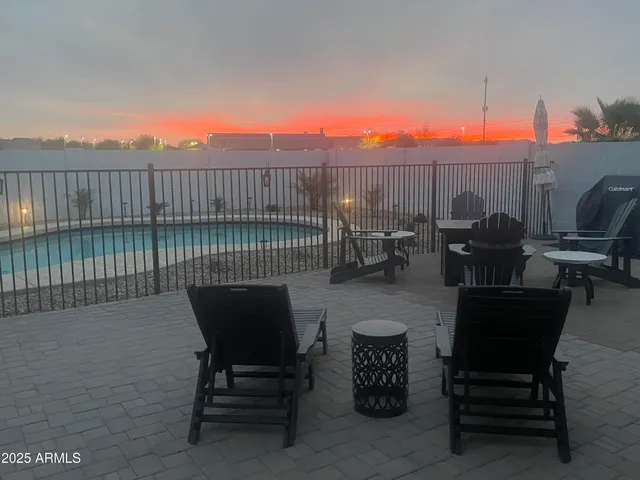 a roof deck with table and chairs