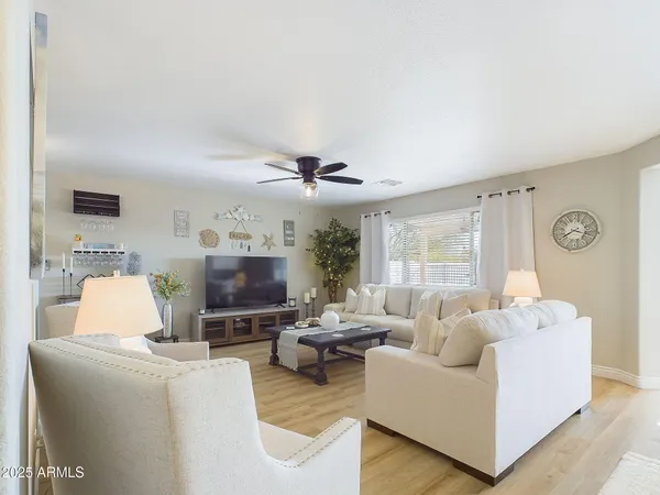 a living room with furniture and a flat screen tv