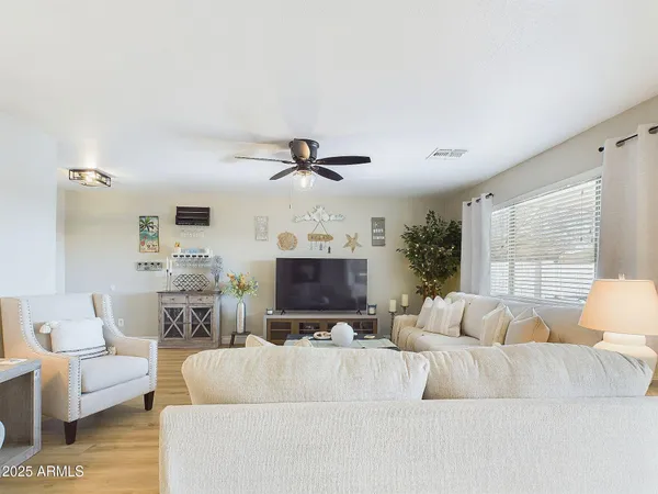 a living room with furniture and a large window