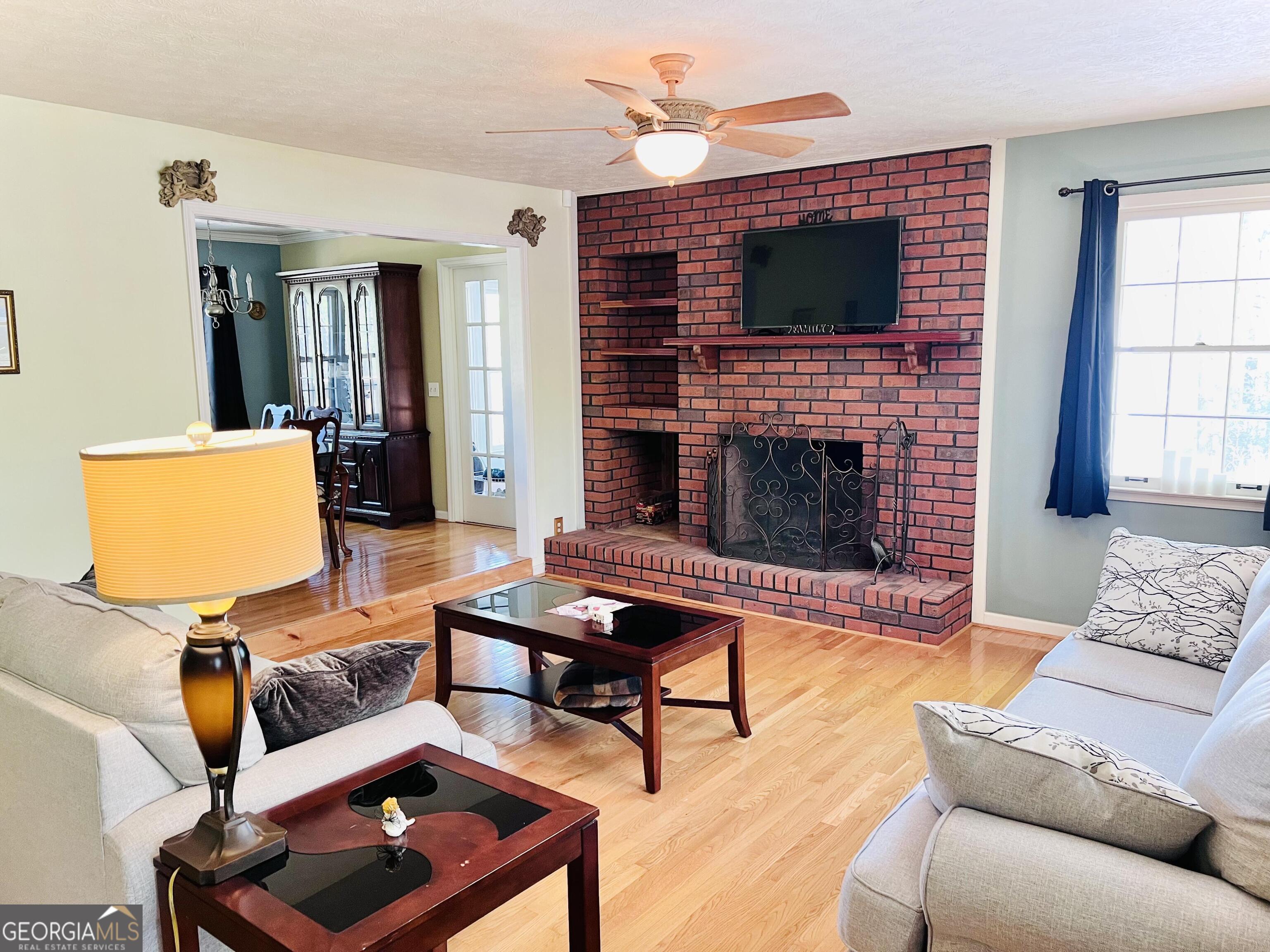 285 Wolf Den Road Royston, GA 30662 - Photo 12 of 61 a living room with furniture fireplace and window
