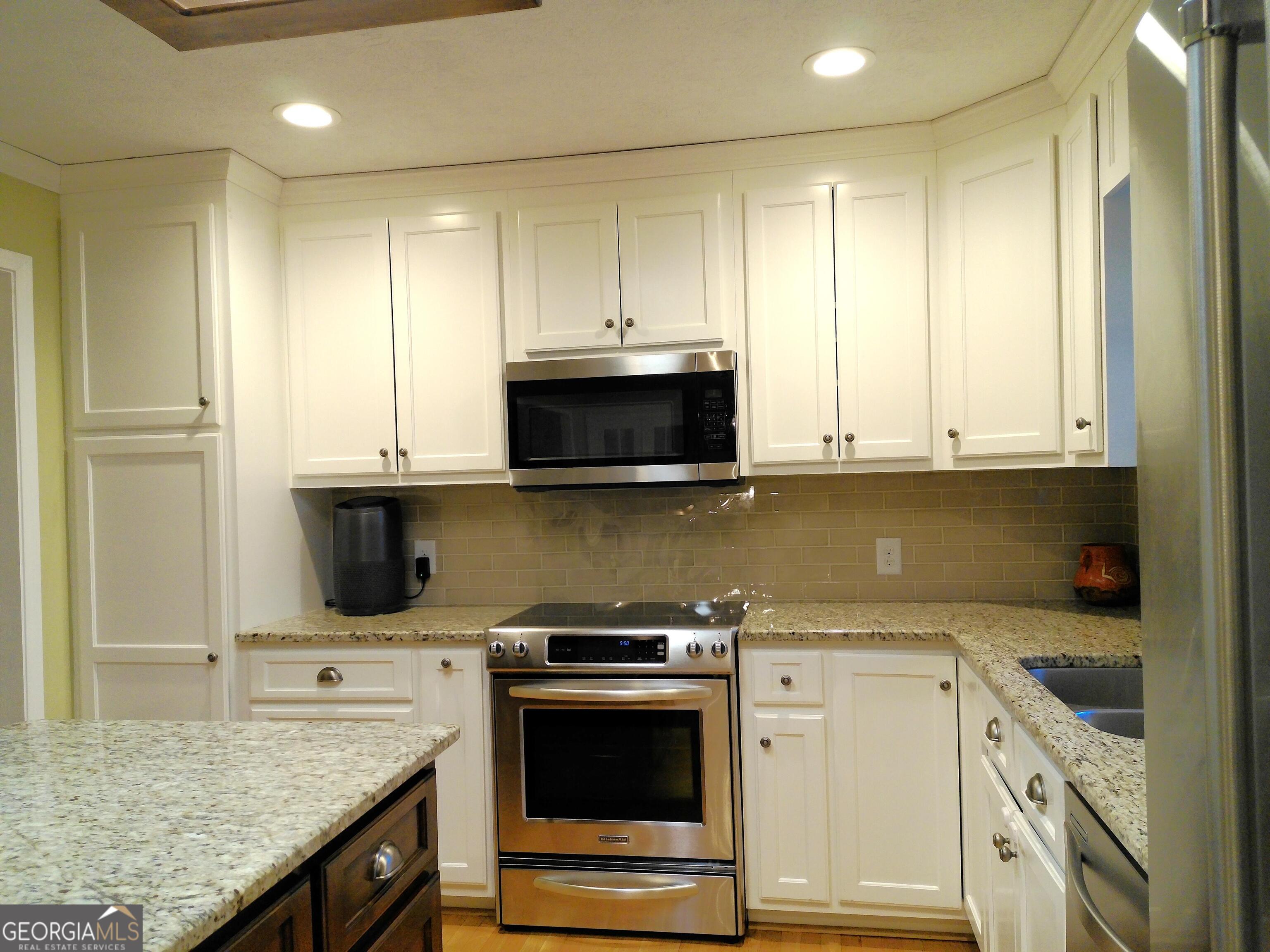 285 Wolf Den Road Royston, GA 30662 - Photo 15 of 60 a kitchen with stainless steel appliances granite countertop a stove and a microwave
