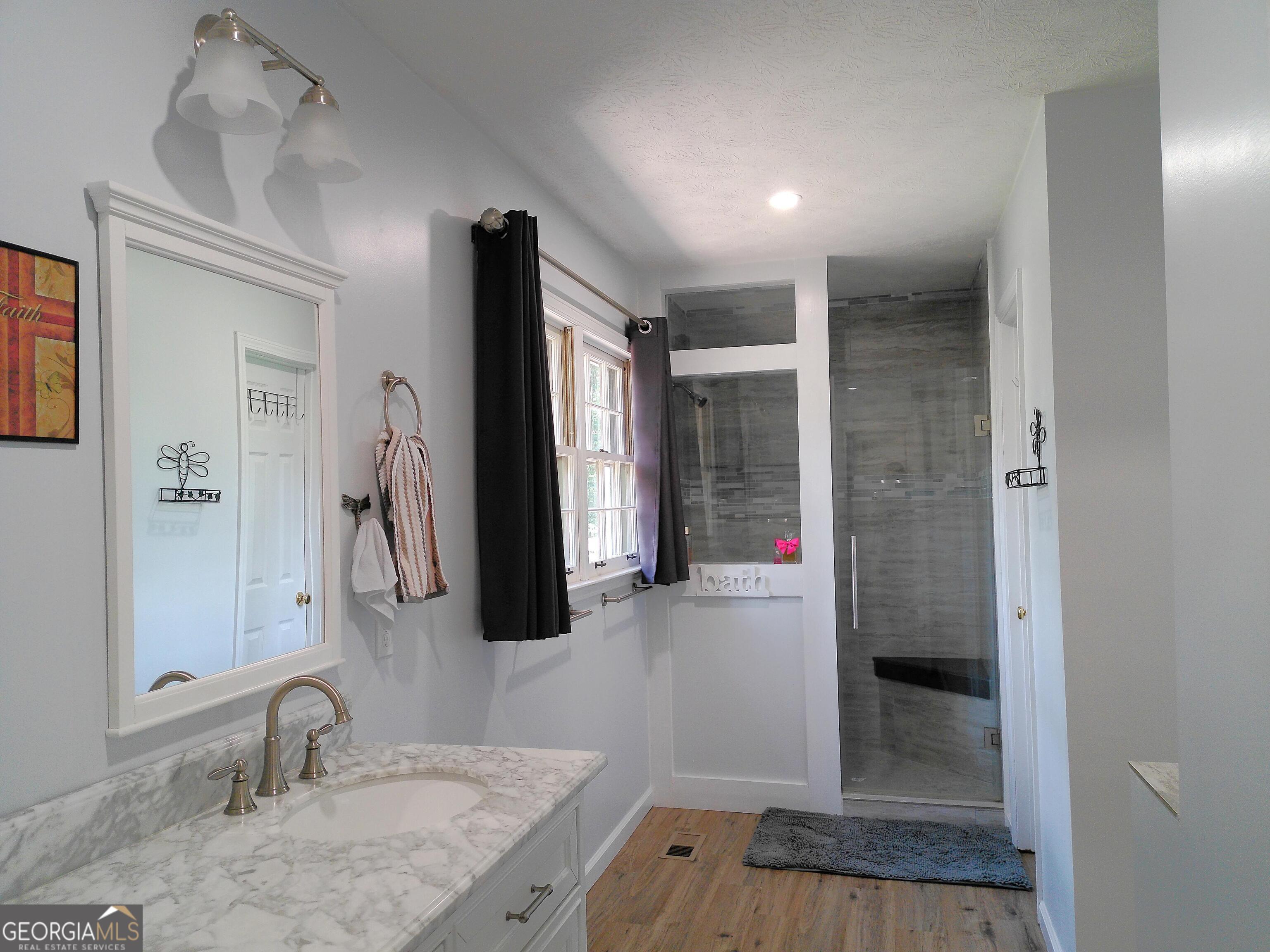285 Wolf Den Road Royston, GA 30662 - Photo 25 of 61 a bathroom with a granite countertop sink and a mirror