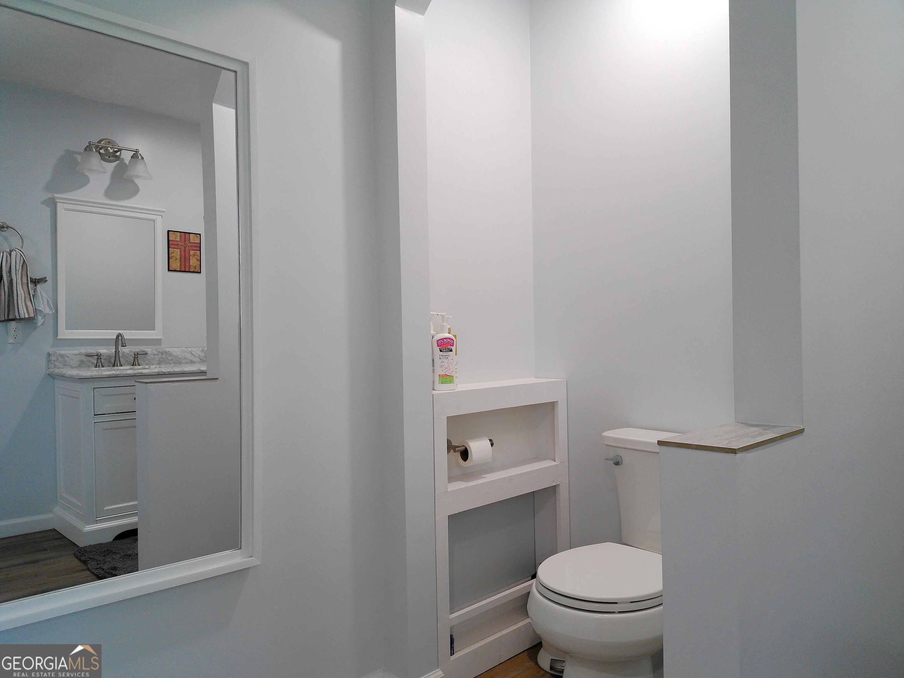 285 Wolf Den Road Royston, GA 30662 - Photo 28 of 60 a white toilet sitting next to a bathroom sink