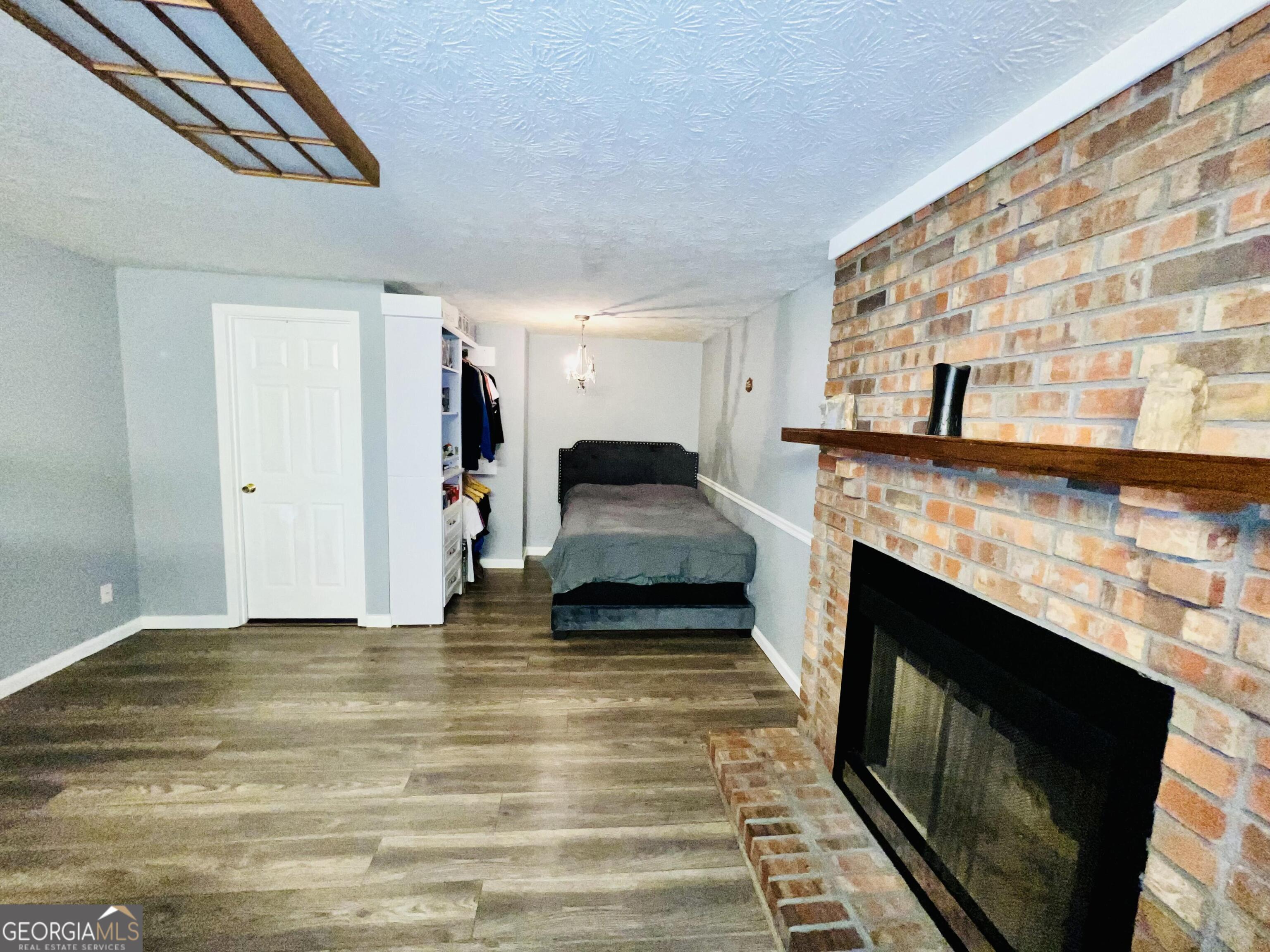 285 Wolf Den Road Royston, GA 30662 - Photo 38 of 60 a living room with a fireplace and a flat screen tv