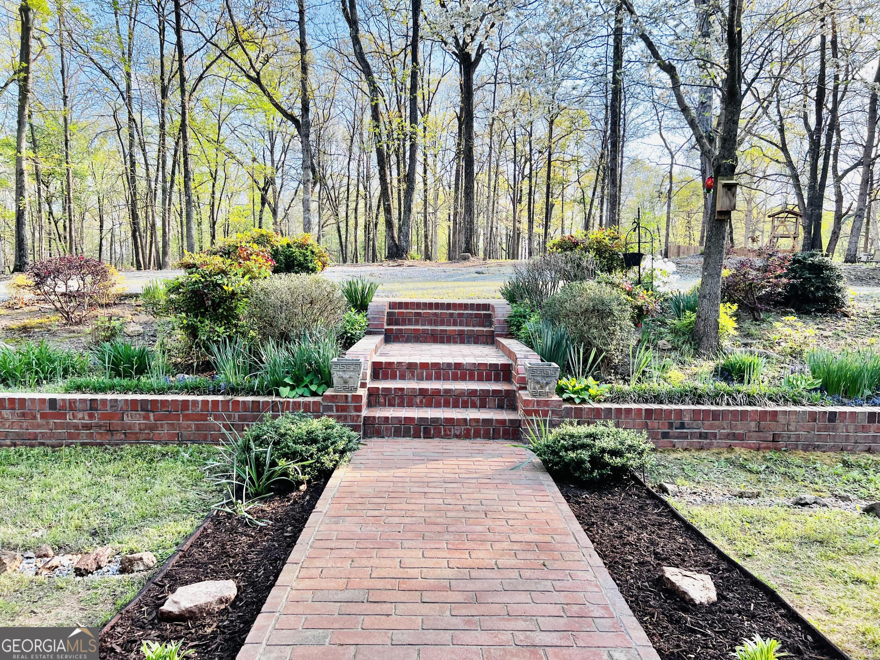 285 Wolf Den Road Royston, GA 30662 - Photo 5 of 60 a front view of a house with a yard and fountain in middle