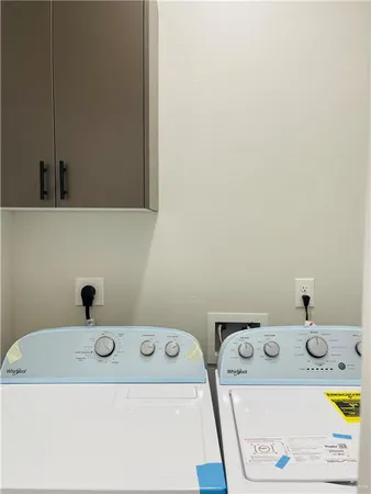 a bathroom with a washing machine and a sink