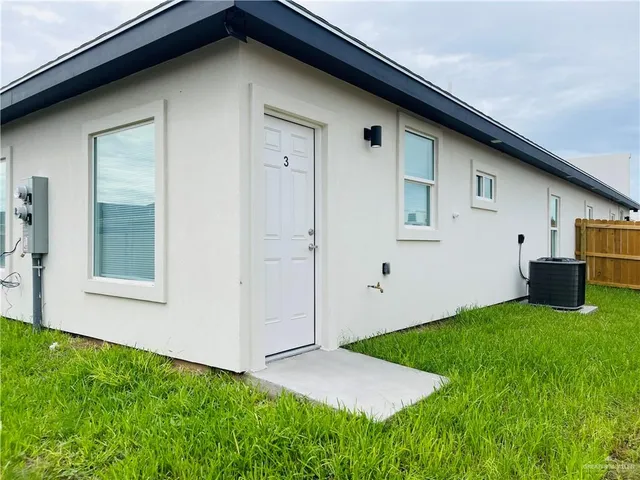 a view of an house with backyard space and windows
