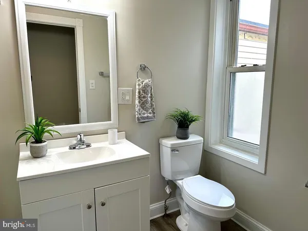 a bathroom with a sink toilet and a mirror