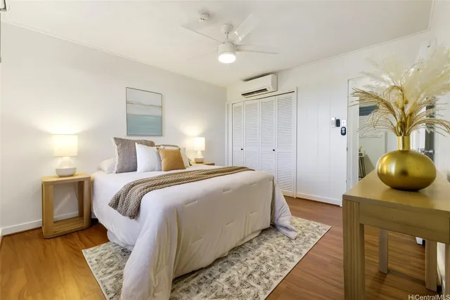 a bedroom with a bed and wooden floor