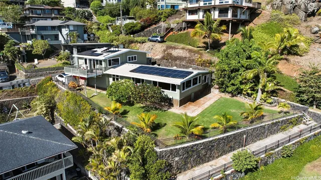an aerial view of a house with a garden and plants