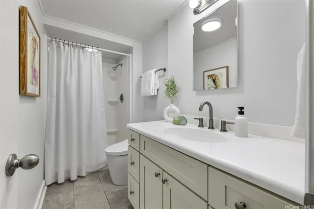 a bathroom with a granite countertop sink a toilet and a mirror