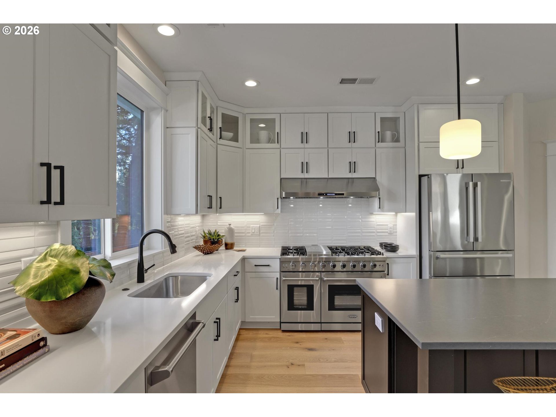4022 Southeast Aldercrest Road Milwaukie, OR 97222 - Photo 14 of 40 a kitchen with kitchen island granite countertop a sink a counter space and stainless steel appliances