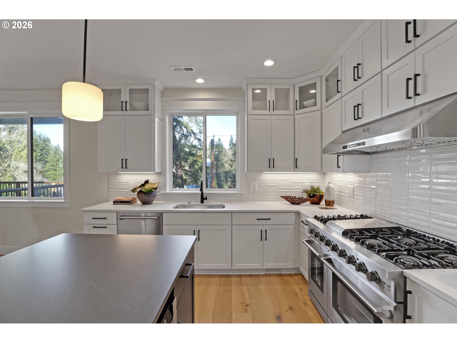 4022 Southeast Aldercrest Road Milwaukie, OR 97222 - Photo 15 of 40 a kitchen that has a lot of cabinets in it and wooden floors