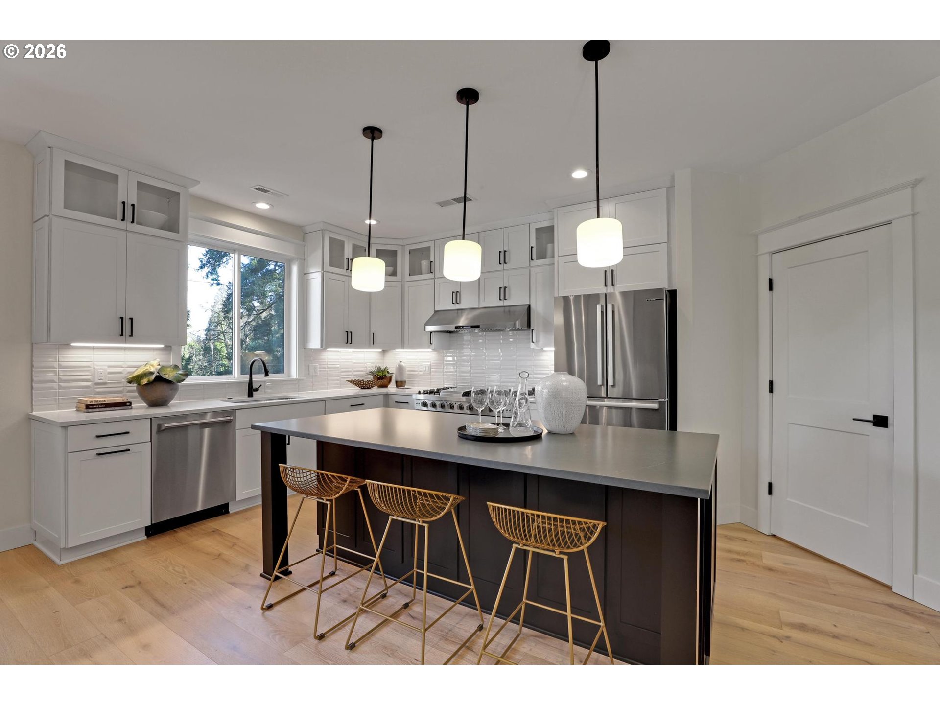 4022 Southeast Aldercrest Road Milwaukie, OR 97222 - Photo 16 of 40 a kitchen with kitchen island granite countertop a sink cabinets and wooden floor