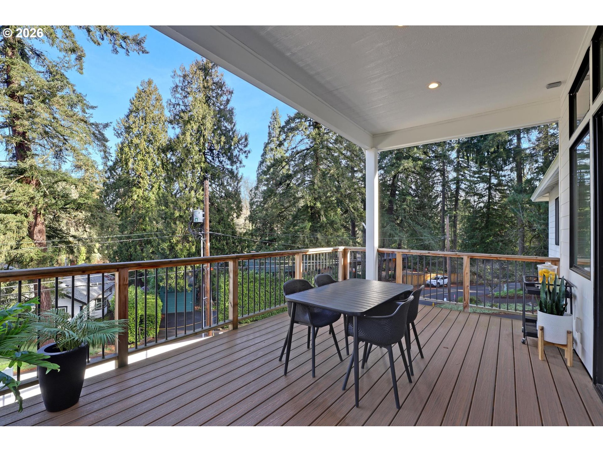 4022 Southeast Aldercrest Road Milwaukie, OR 97222 - Photo 32 of 40 a balcony with wooden floor table and chairs