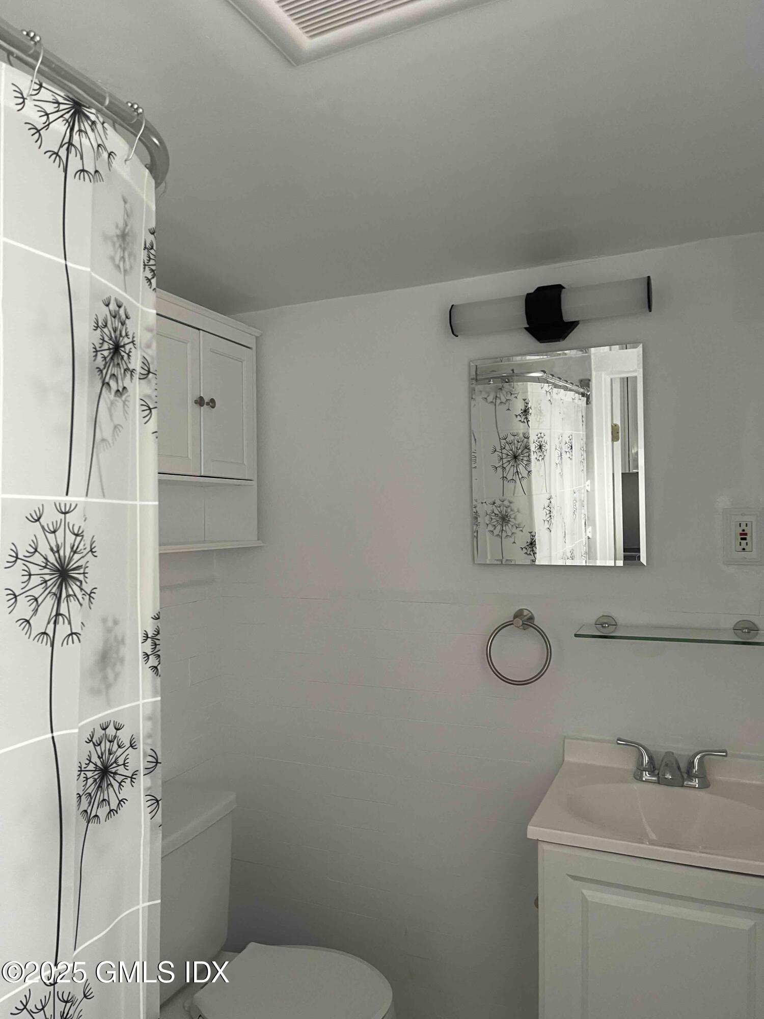 47 Cos Cob Avenue, Unit 3 Cos Cob, CT 06807 - Photo 12 of 12 a bathroom with a sink and mirror
