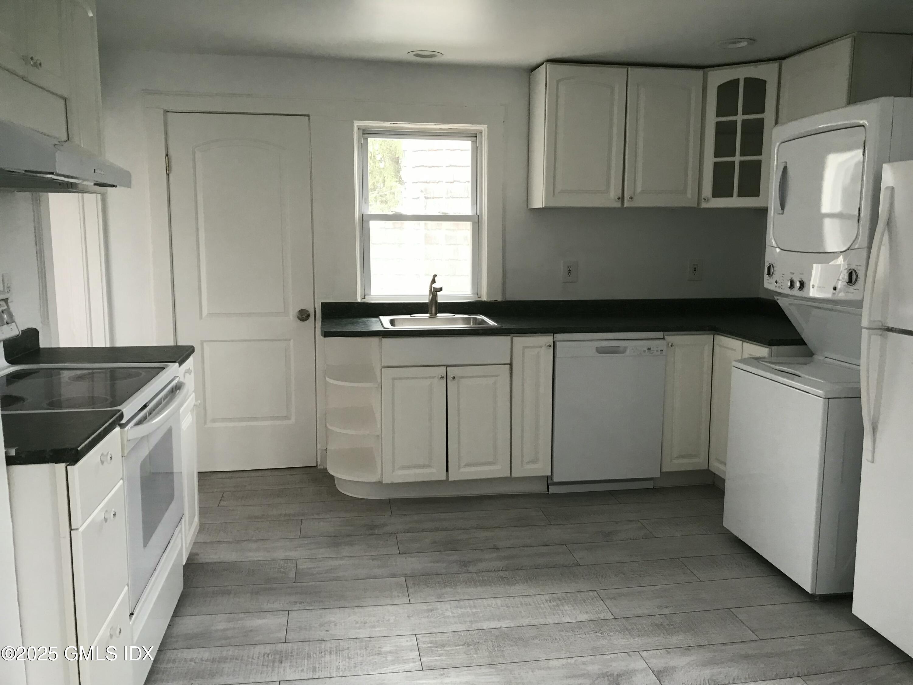 47 Cos Cob Avenue, Unit 3 Cos Cob, CT 06807 - Photo 4 of 12 a kitchen with stainless steel appliances granite countertop a sink stove and refrigerator