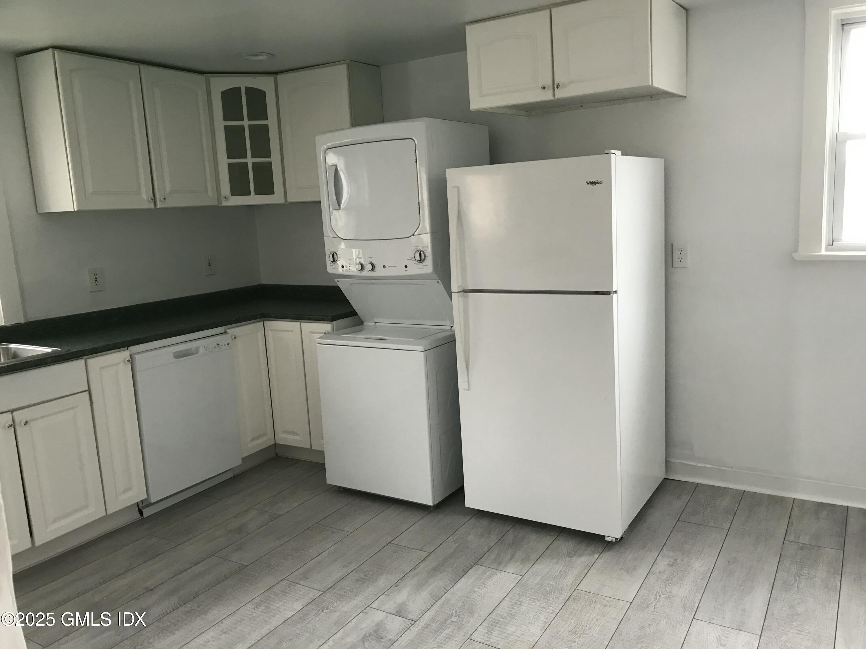 47 Cos Cob Avenue, Unit 3 Cos Cob, CT 06807 - Photo 5 of 12 a white refrigerator freezer sitting inside of a kitchen