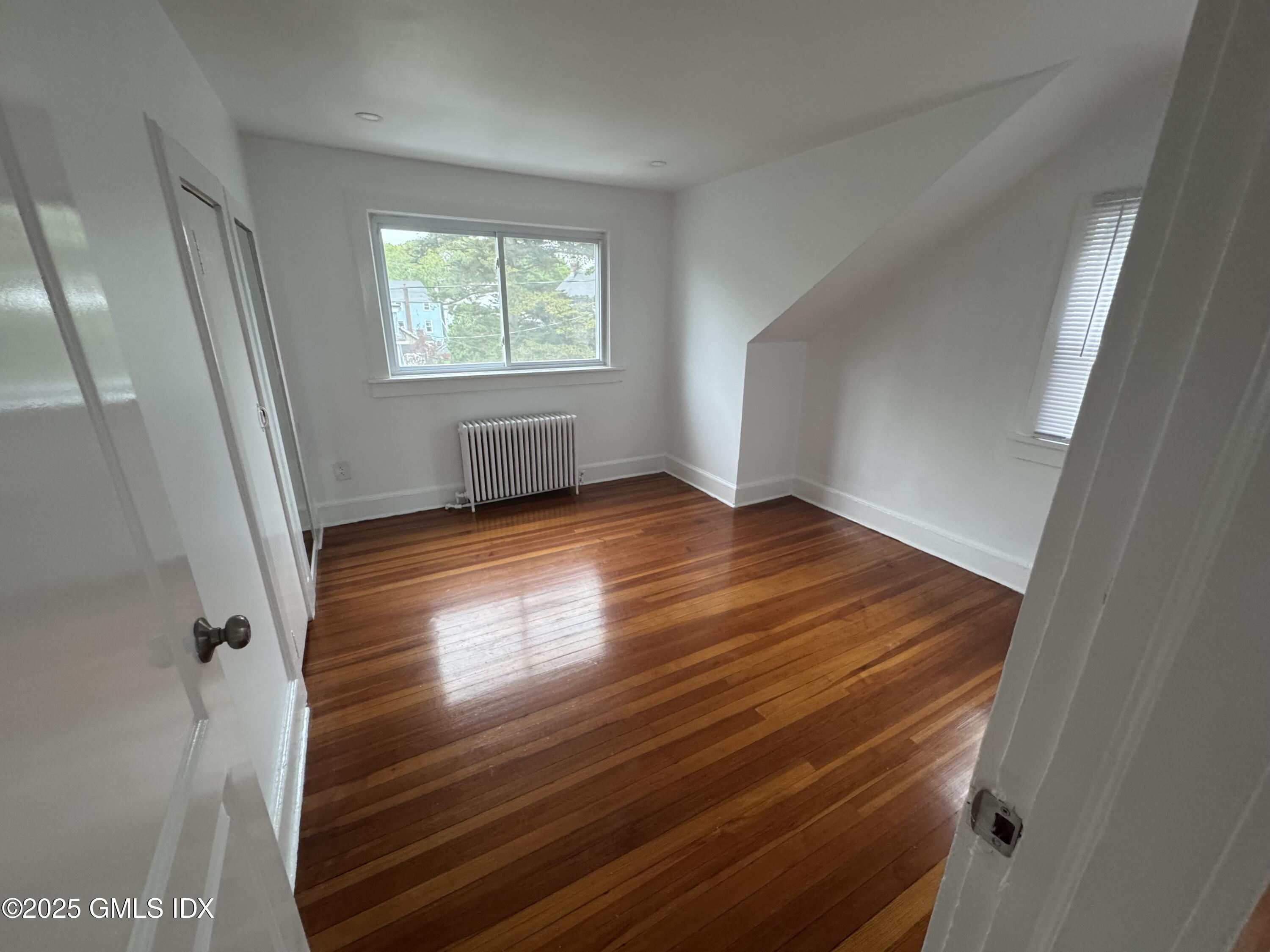 47 Cos Cob Avenue, Unit 3 Cos Cob, CT 06807 - Photo 10 of 12 wooden floor in an empty room with a window