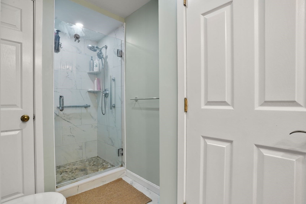 1 Commodore Court, Unit 104 Hull, MA 02045 - Photo 18 of 35 a bathroom with a shower