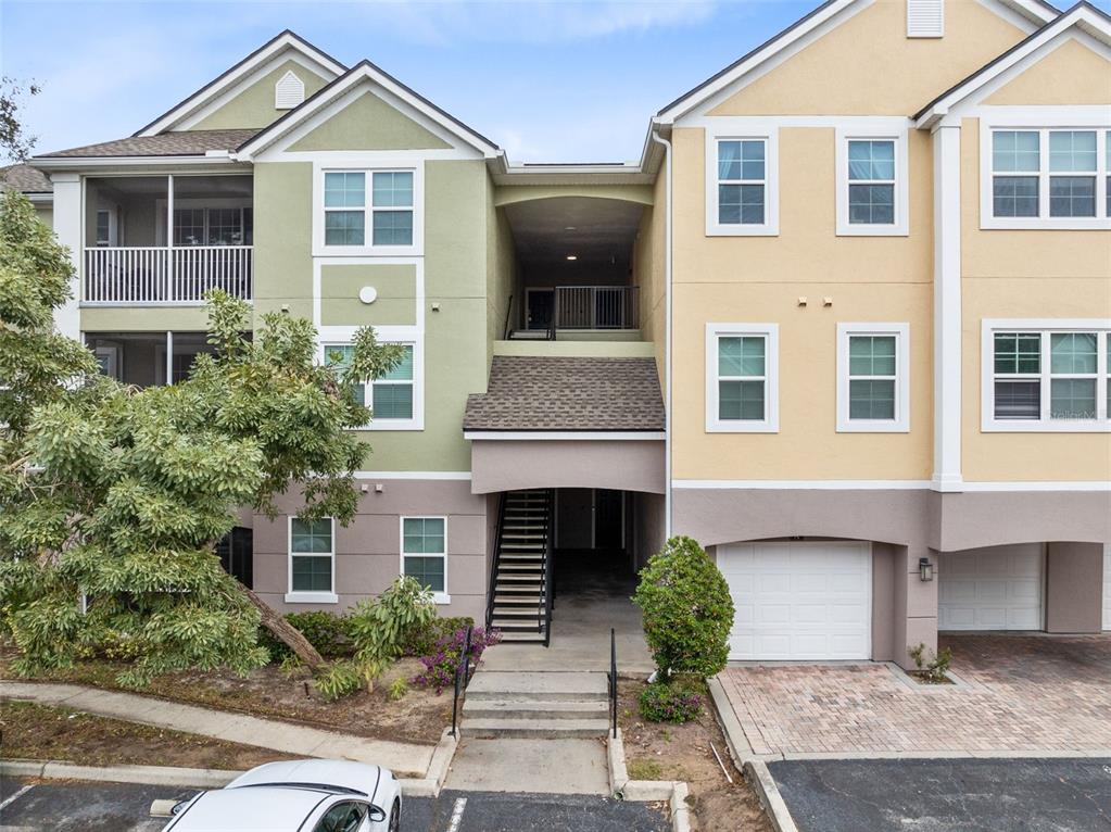 3315 Parkchester Square Boulevard, Unit 102 Orlando, FL 32835 - Photo 1 of 37 a front view of a house with garden