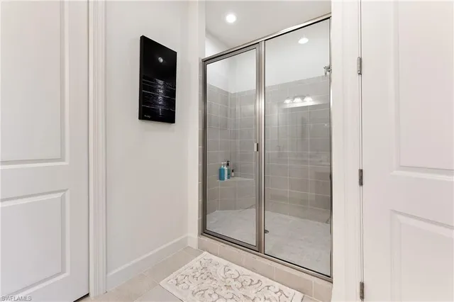 a bathroom with a glass shower door