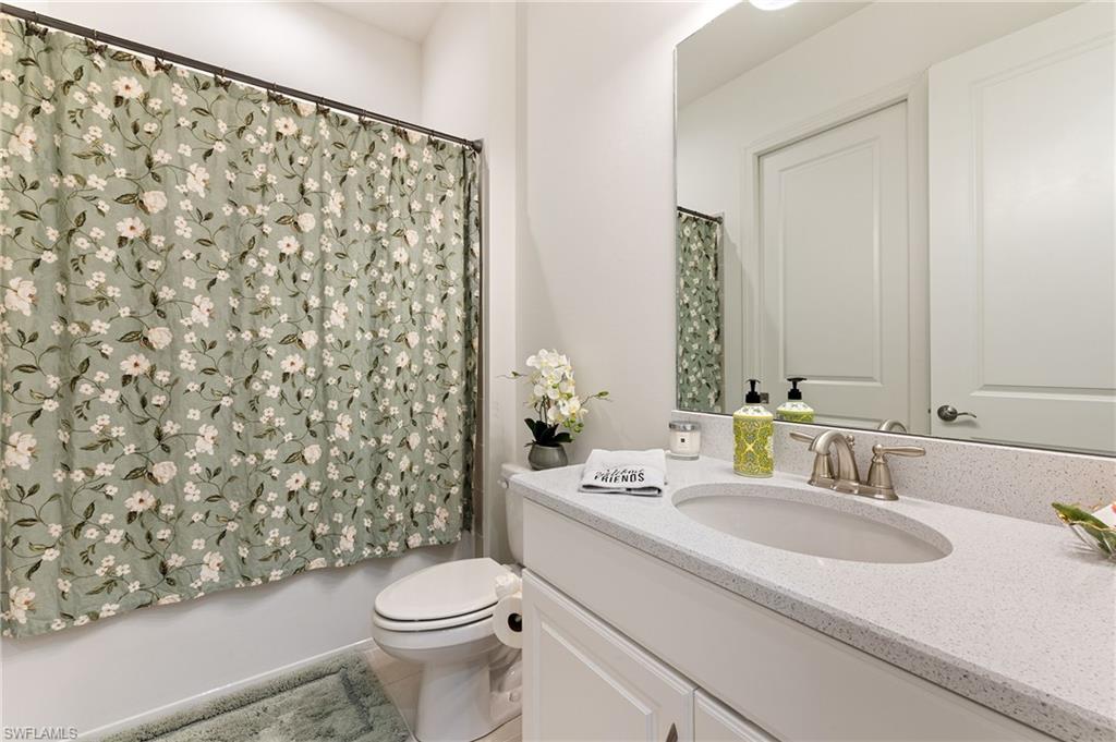 9653 Montelanico Loop, Unit 202 Naples, FL 34119 - Photo 21 of 45 a bathroom with a sink toilet and shower