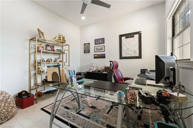 a living room with furniture a flat screen tv and gym equipment