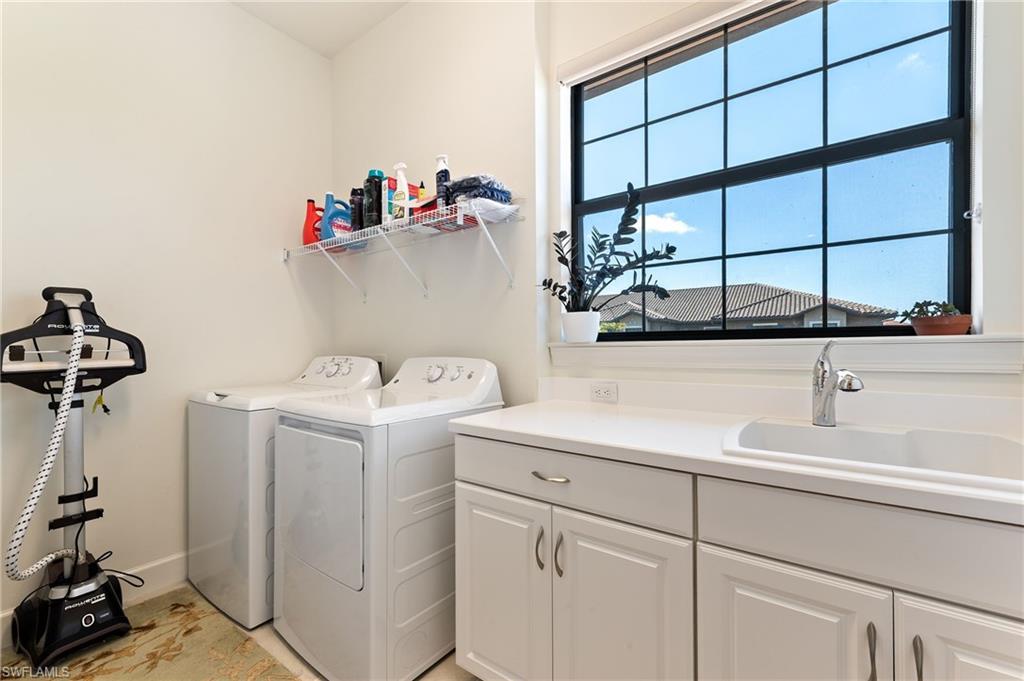 9653 Montelanico Loop, Unit 202 Naples, FL 34119 - Photo 24 of 45 a utility room with dryer and washer