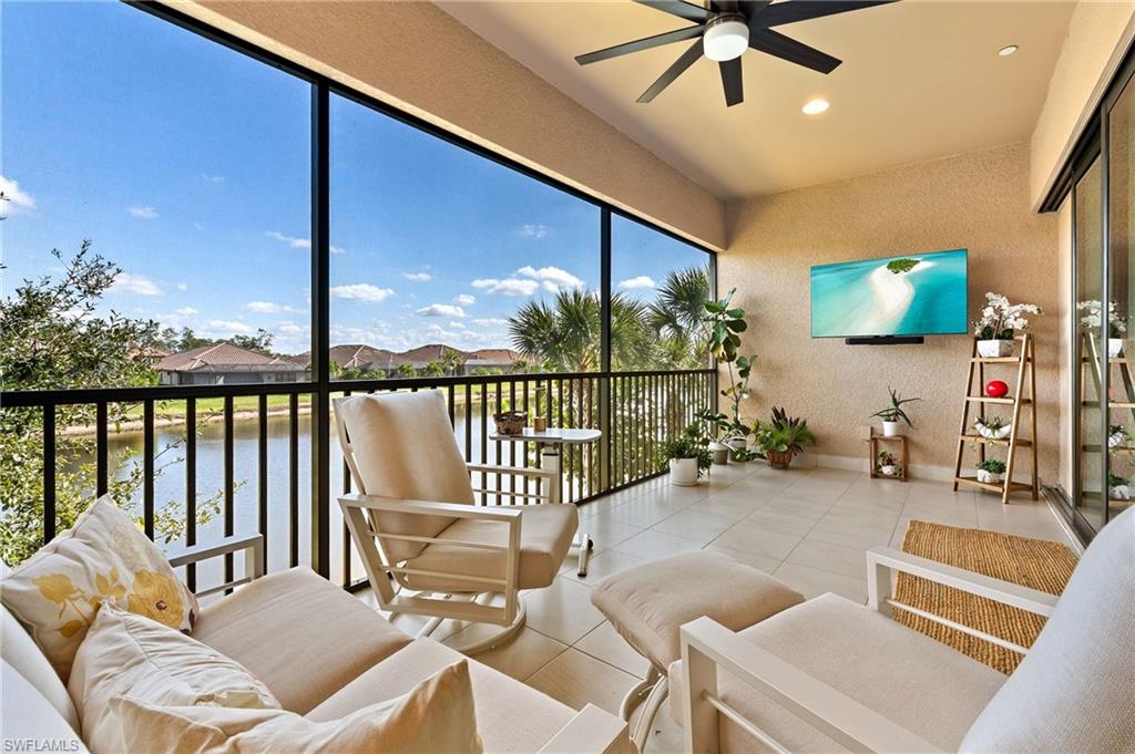 9653 Montelanico Loop, Unit 202 Naples, FL 34119 - Photo 26 of 45 a outdoor living space with furniture and a flat screen tv