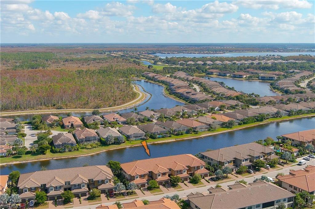 9653 Montelanico Loop, Unit 202 Naples, FL 34119 - Photo 32 of 45 an aerial view of a house with a lake view