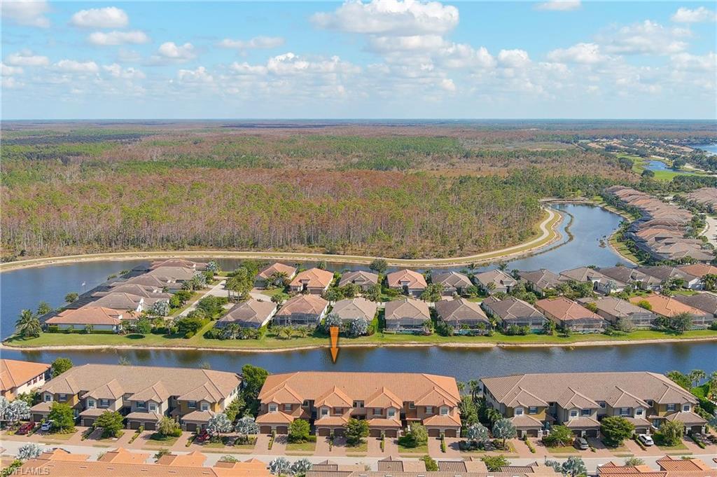 9653 Montelanico Loop, Unit 202 Naples, FL 34119 - Photo 33 of 45 a view of a lake with a nearby beach