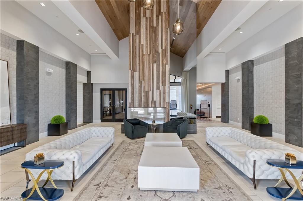 9653 Montelanico Loop, Unit 202 Naples, FL 34119 - Photo 36 of 45 a living room with furniture and wooden floor