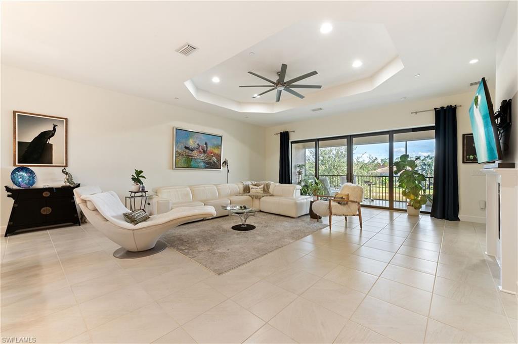 9653 Montelanico Loop, Unit 202 Naples, FL 34119 - Photo 7 of 45 a living room with furniture and a large window