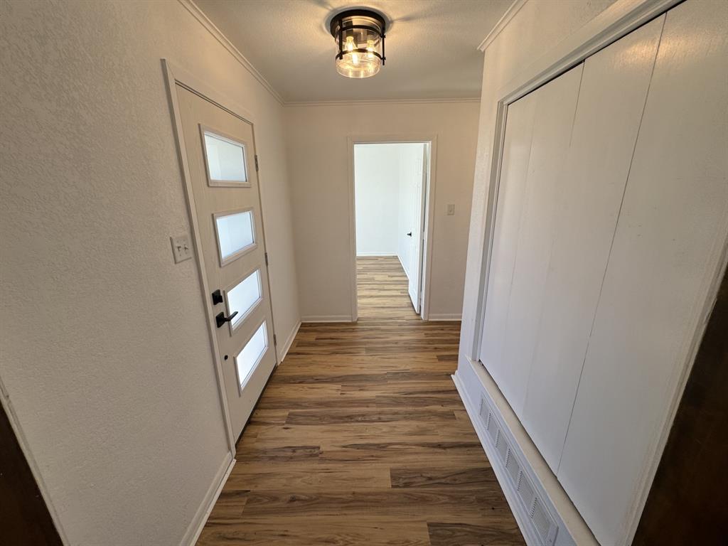 520 County Road Powderly, TX 75473 - Photo 12 of 24 Hall featuring dark hardwood / wood-style flooring and ornamental molding