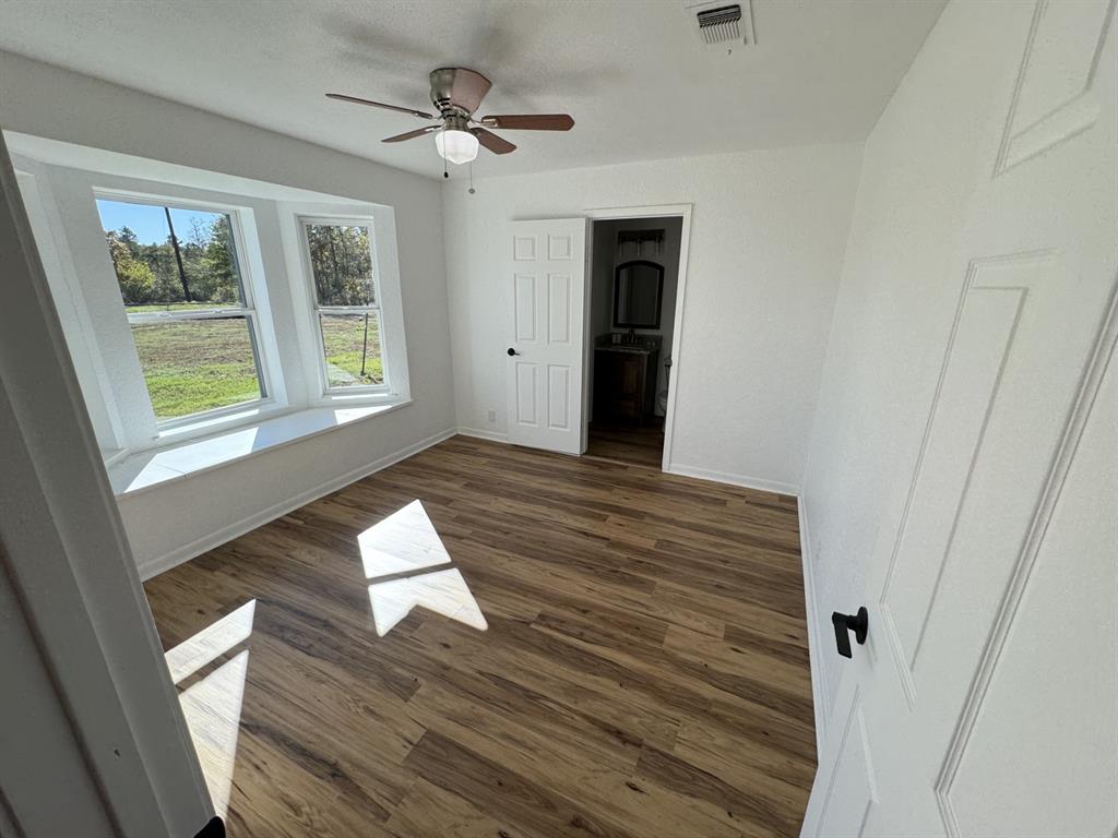 520 County Road Powderly, TX 75473 - Photo 16 of 24 Spare room with ceiling fan and dark hardwood / wood-style flooring