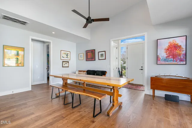 a room with furniture pool table and wooden floor