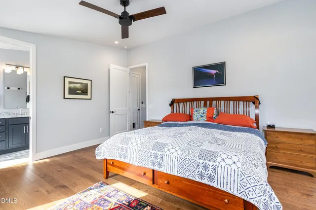 a bedroom with a bed and wooden floor