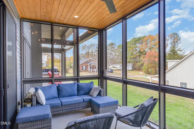 a living room with furniture and a floor to ceiling window