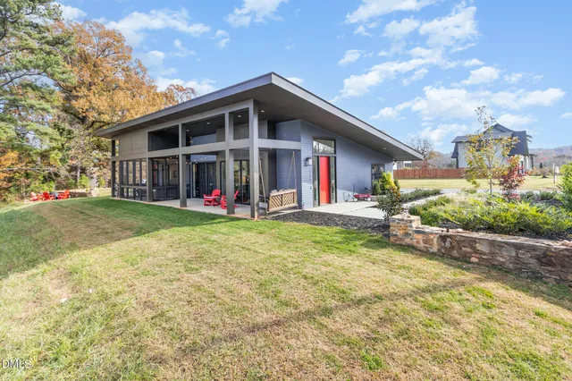 a view of a house with big yard and plants