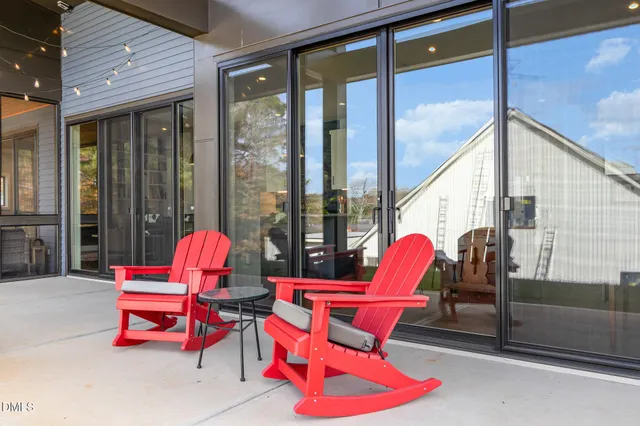 a front view of a house with outdoor seating