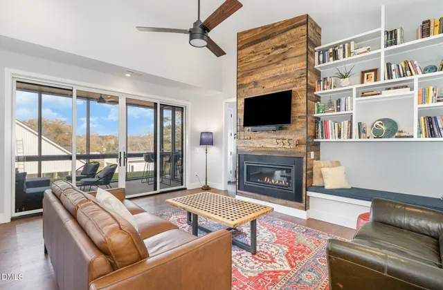 a living room with fireplace furniture and a flat screen tv