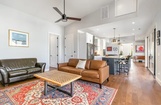 a living room with furniture a rug and a table