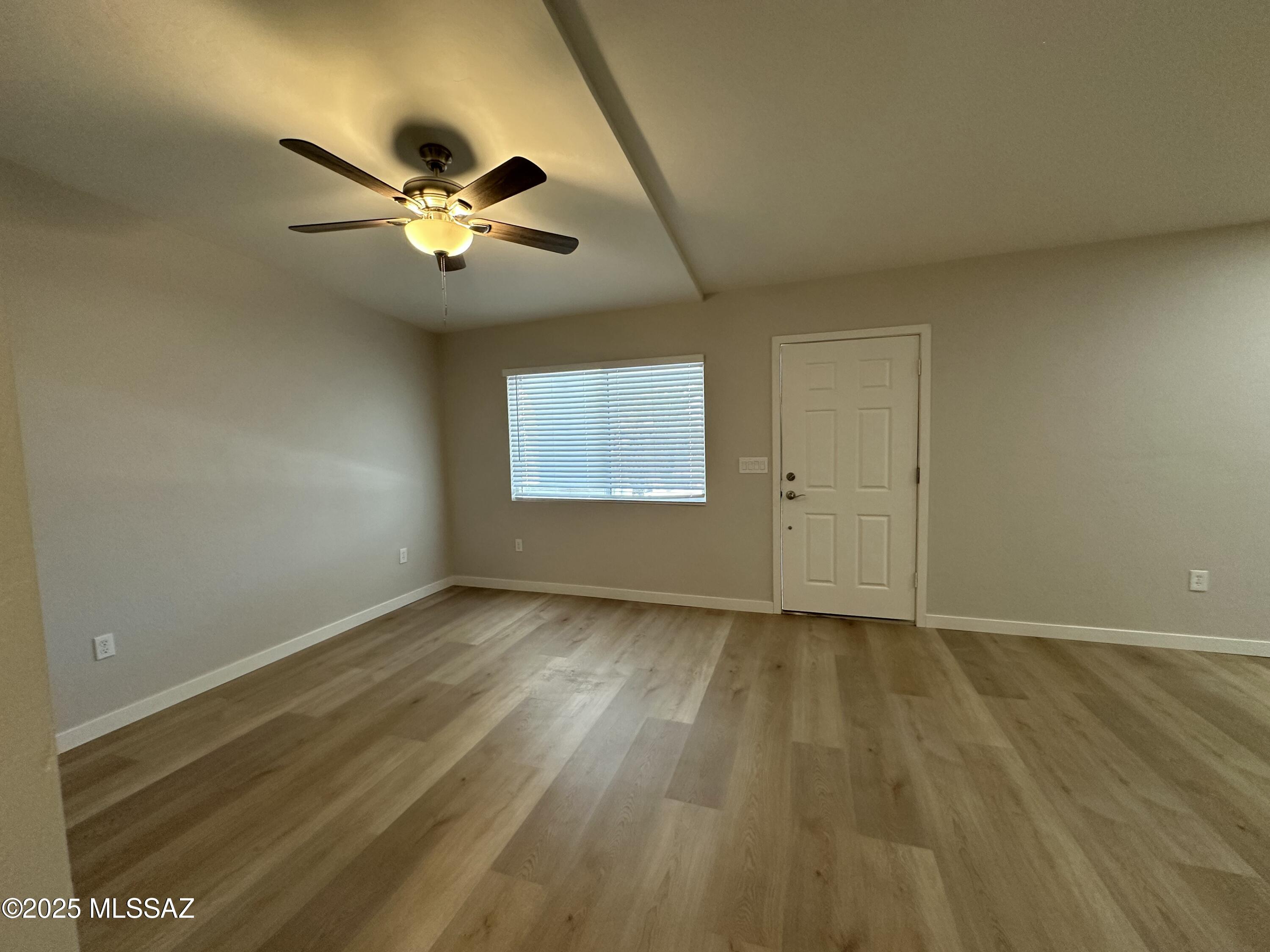 645 East Mabel Street Tucson, AZ 85705 - Photo 2 of 22 a view of an empty room with chandelier fan and a window