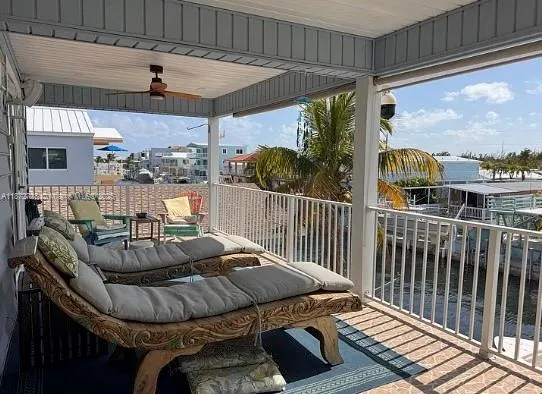 a view of a balcony with furniture