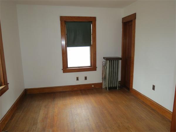 72 Edgemont Road Braintree, MA 02184 - Photo 6 of 11 an empty room with a window and wooden floor