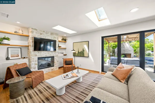 a bedroom with furniture a flat screen tv and a fireplace