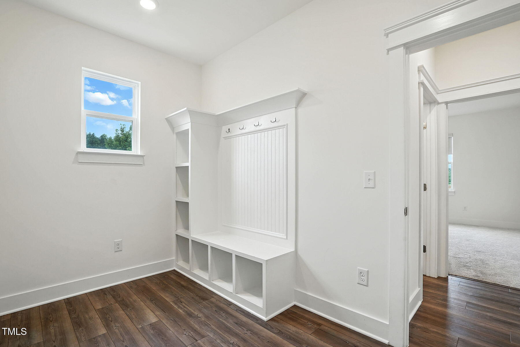 801 Mdw Frd Way Willow Spring, NC 27592 - Photo 16 of 36 a view of an empty room with wooden floor and a window